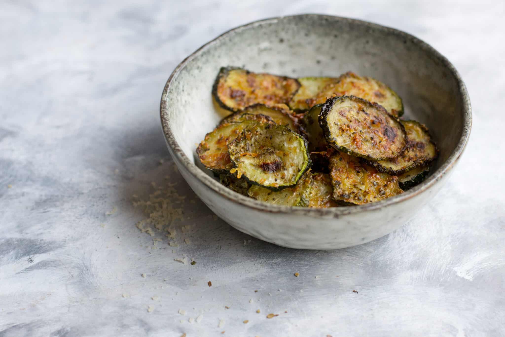 Baked keto courgette chips in a small bowl