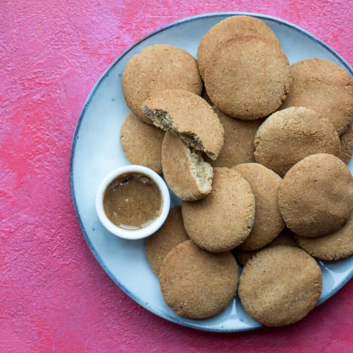 Keto peanut butter cookies and peanut butter in a bowl