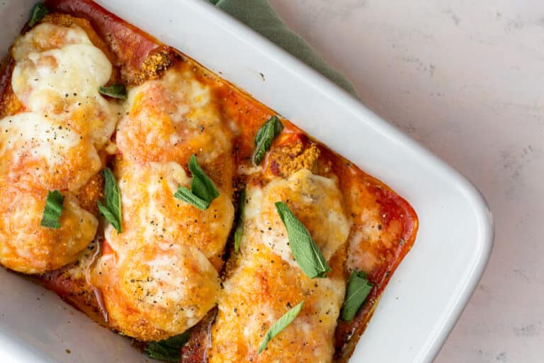 Cooked keto chicken parmesan with fresh sage