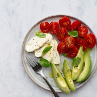 Mozzarella, tomatoes and avocado on a plate