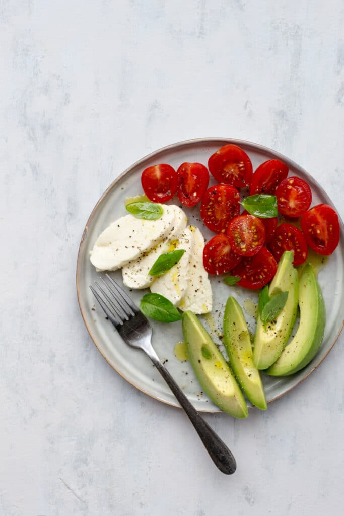 Mozzarella, tomatoes and avocado on a plate