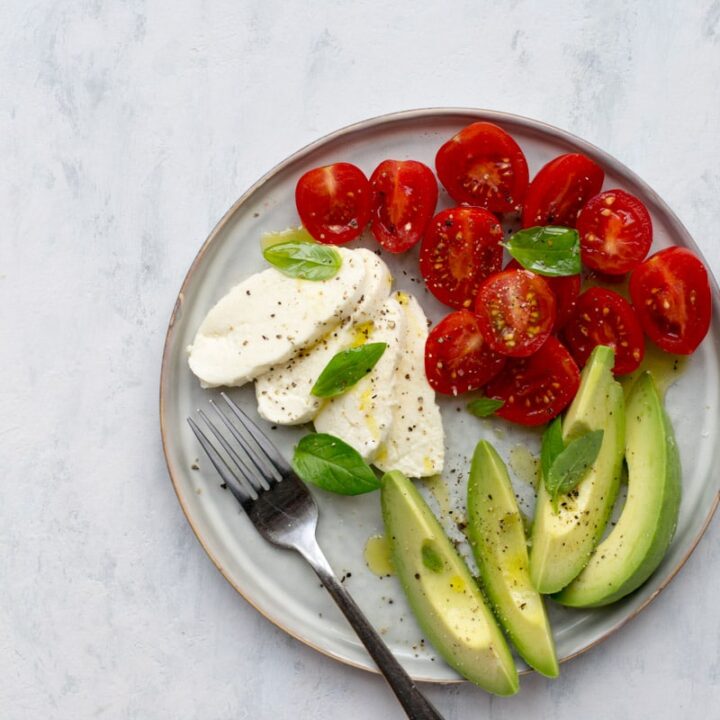 Mozzarella, tomatoes and avocado on a plate